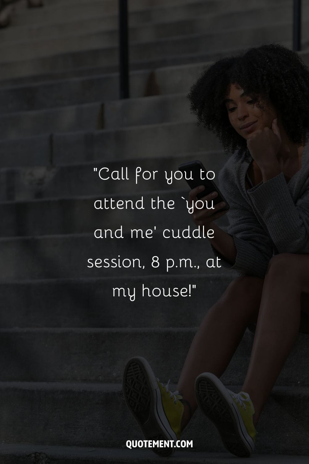 black girl seated on the stairs, engrossed in her phone