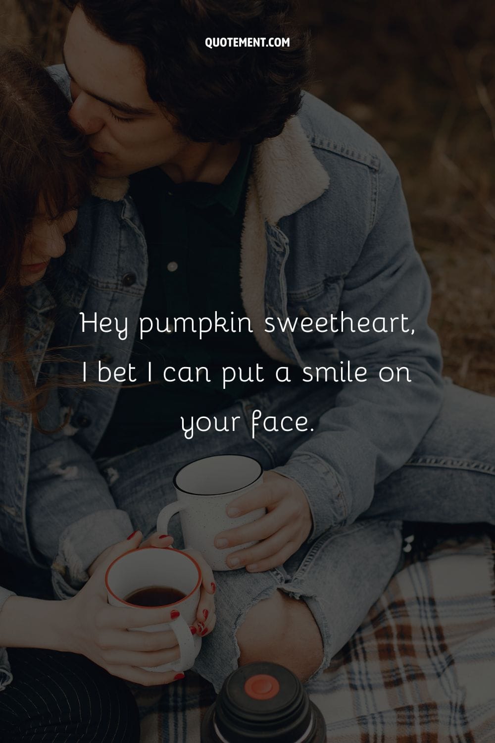 couple sharing a sweet kiss on a leaf-covered ground