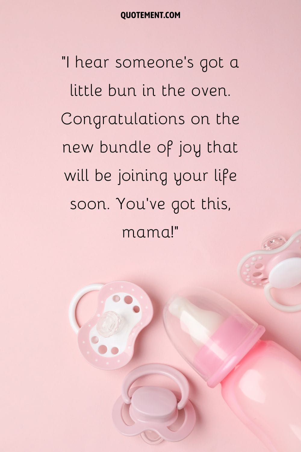 delicate pink pacifiers and a baby bottle on a matching background