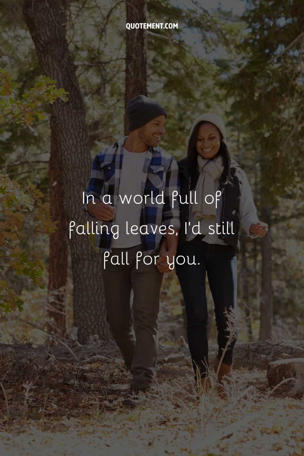 romantic couple hand in hand on leaf-covered ground