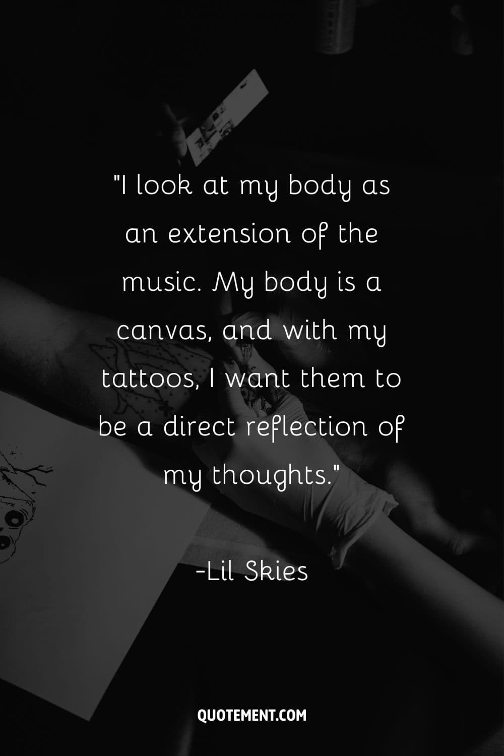 woman artist tattooing a design on skin