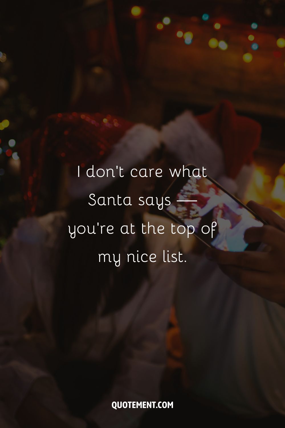 A person taking a photo of a smiling couple in Santa's hats representing an irresistible