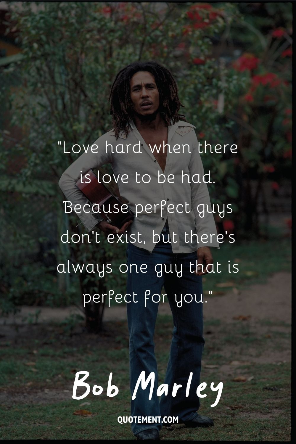 Bob Marley posing in a white shirt and denim pants
