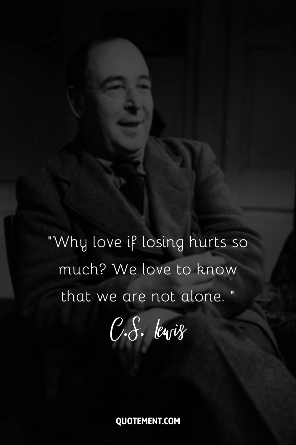 C.S. Lewis sits with a content smile