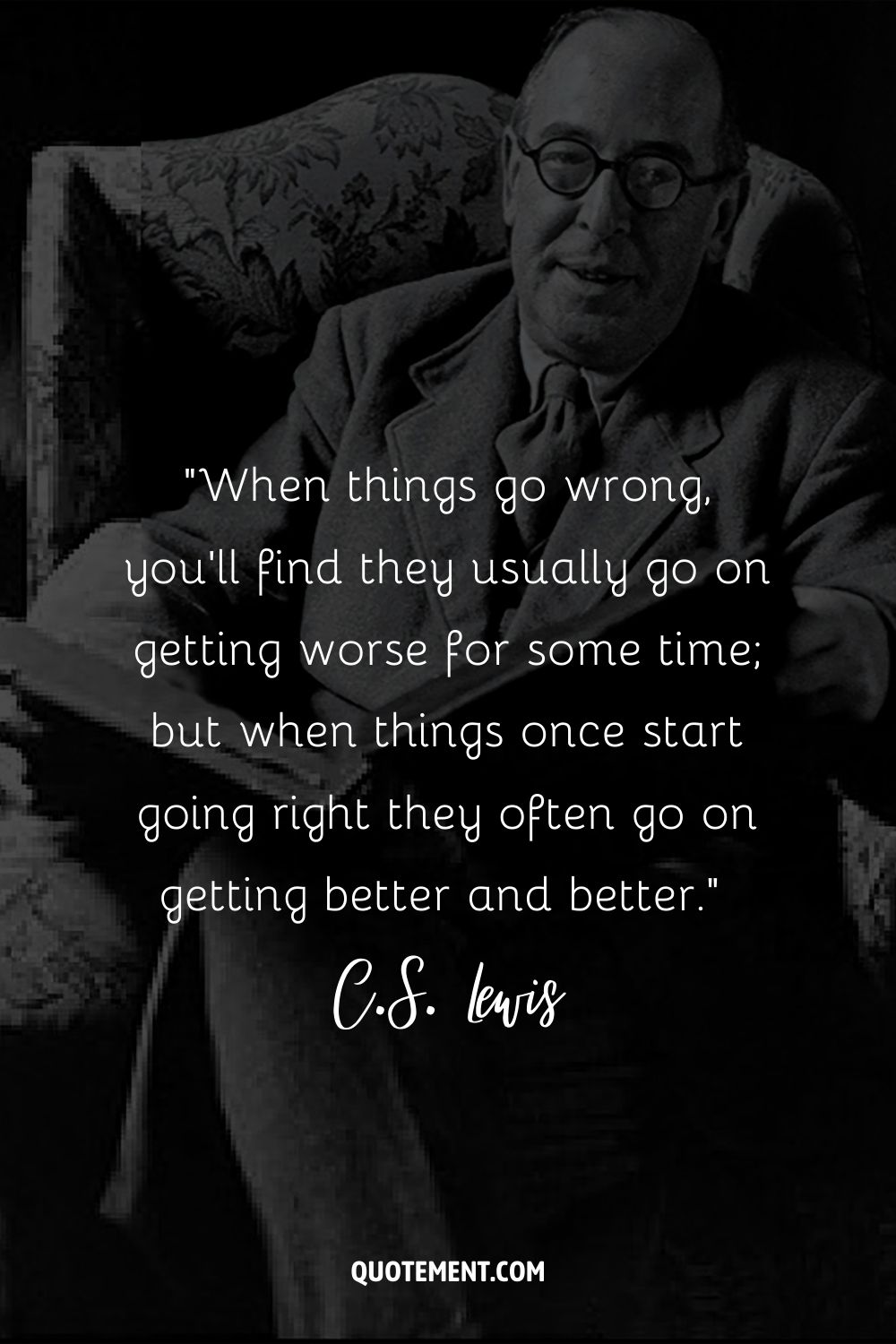 C.S. Lewis, sitting in a chair with a book in hand, wearing a gentle smile