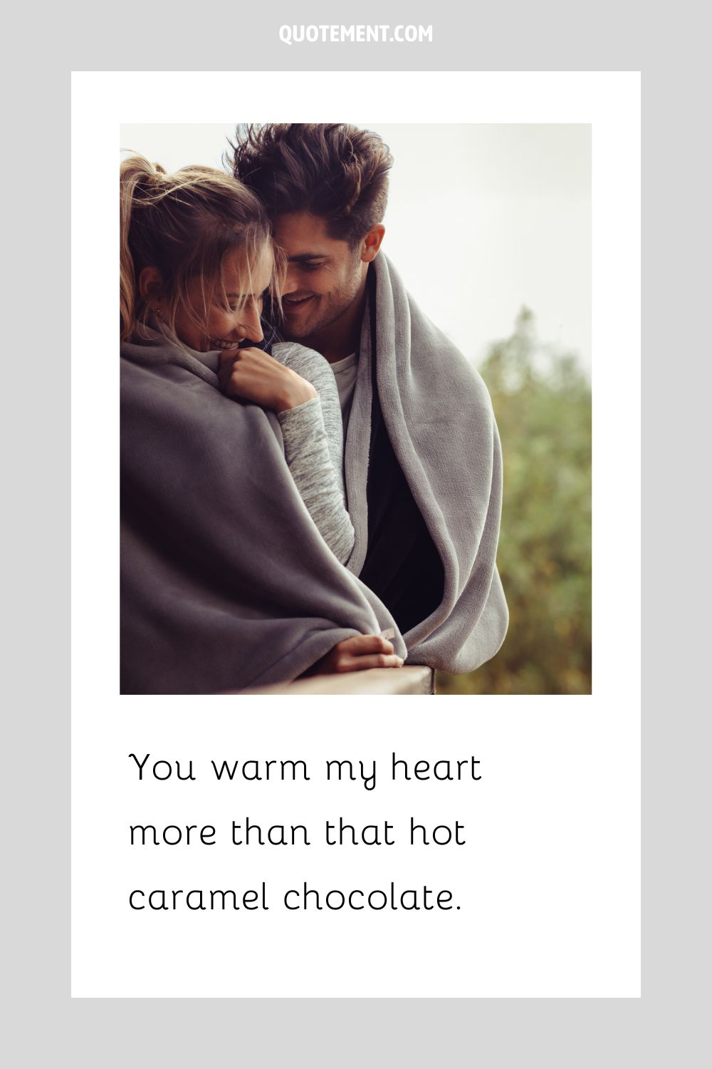 a couple smiling while wrapped in a blanket representing the top winter pick up line