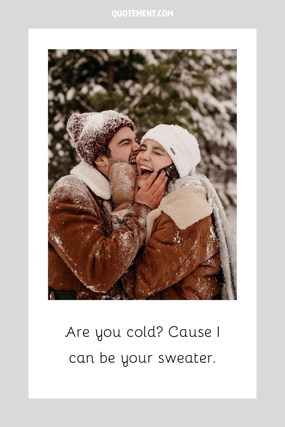 a happy couple shares a warm hug and laughter on a snowy day