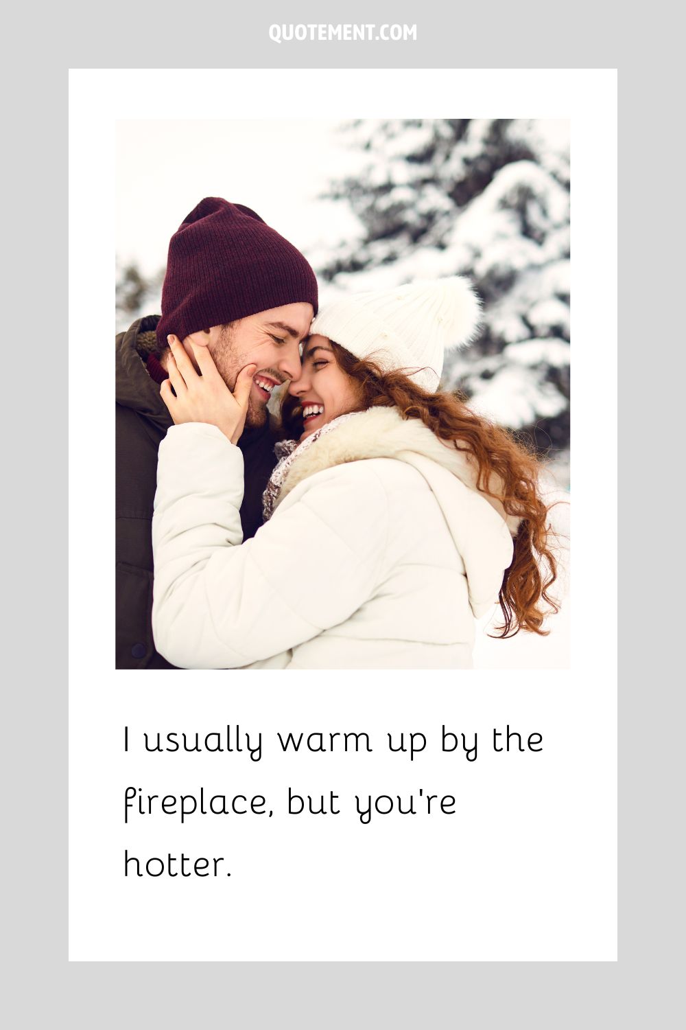 a smiling couple shares a cuddle on a snowy day