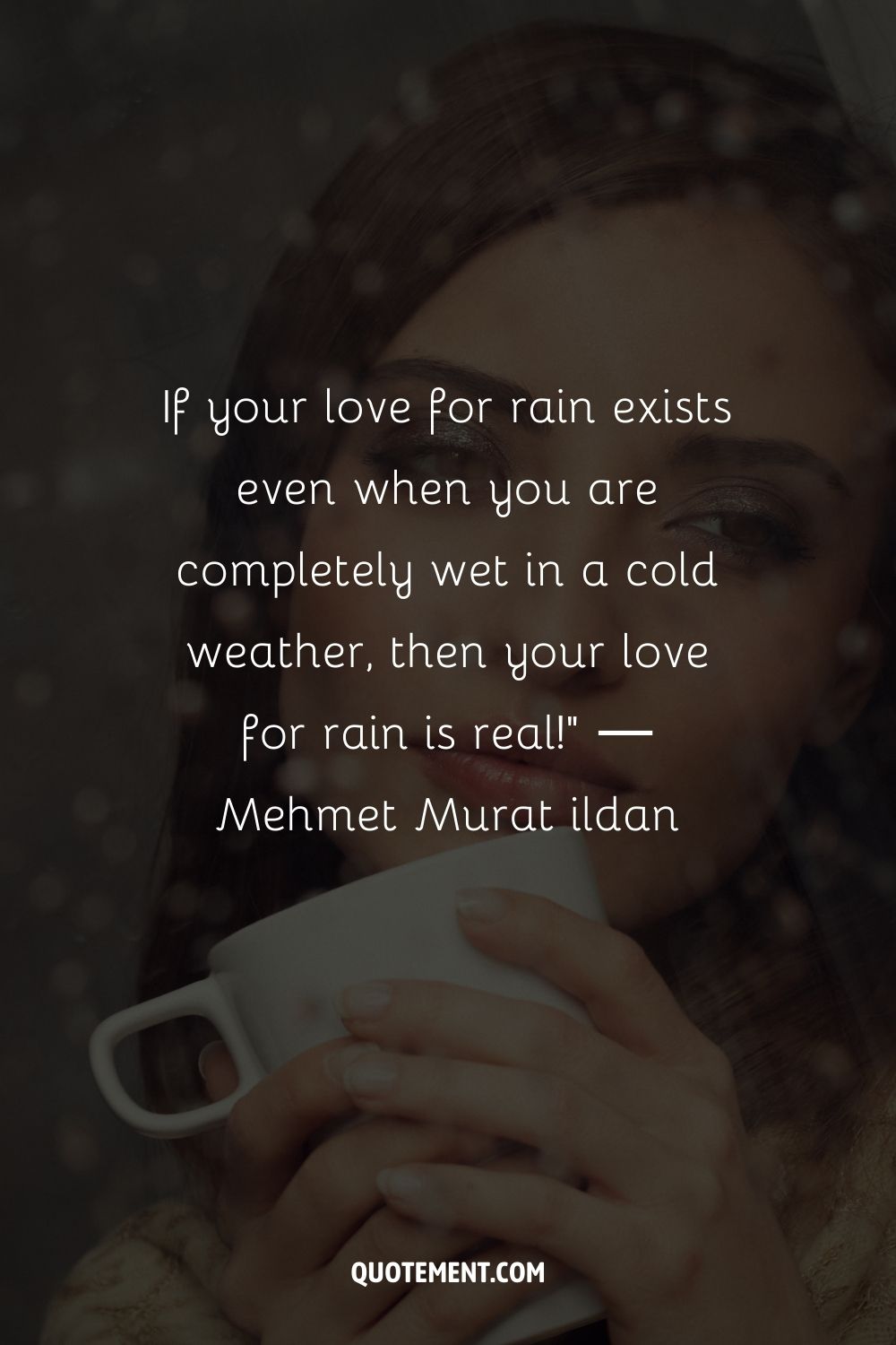 A woman with a mug lookiing out of a rain-splattered window
