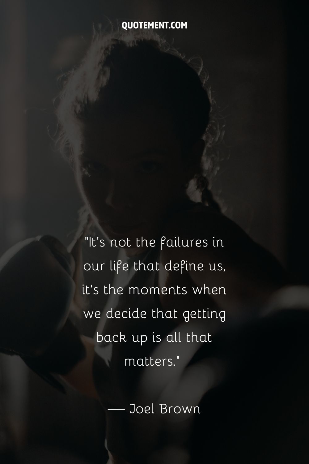 The dark outline of a woman's face, her hair pulled back, in a boxing pose
