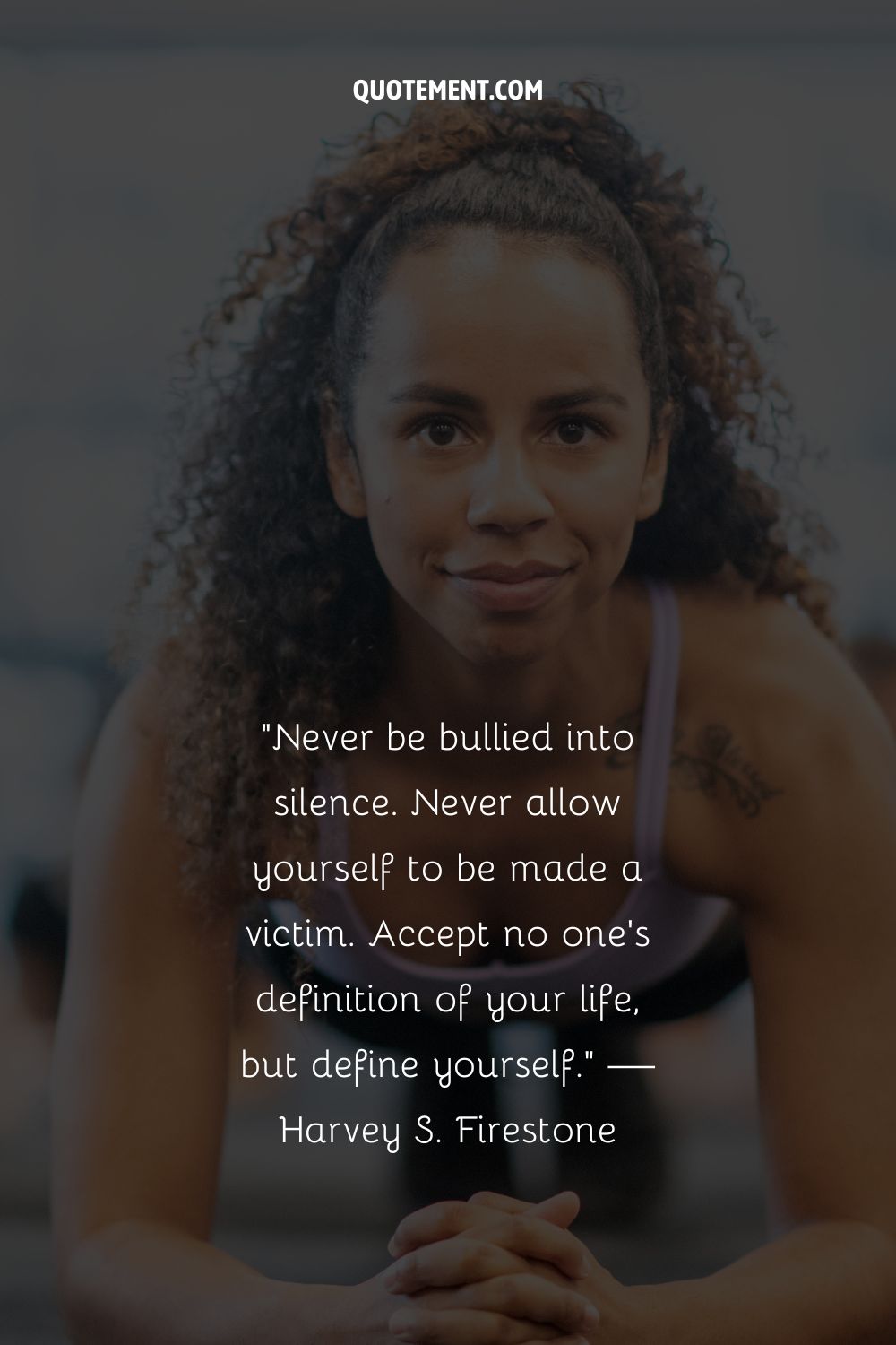 A black woman doing planks representing an anti- bully quote
