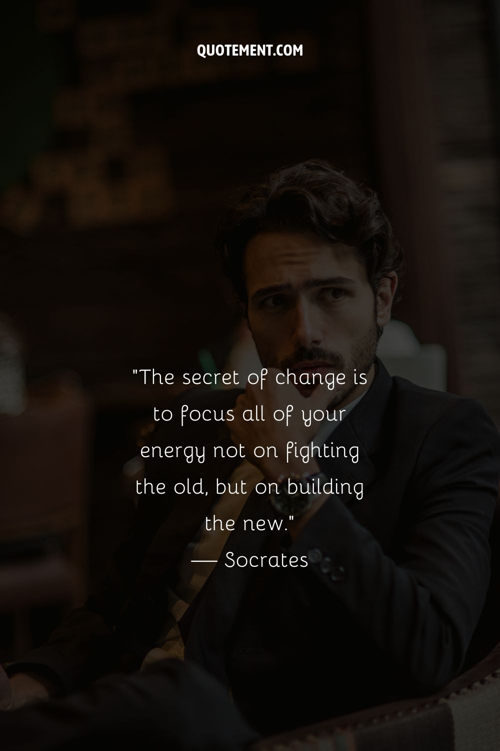 A handsome guy sitting in a chair representing an inspirational quote about change
