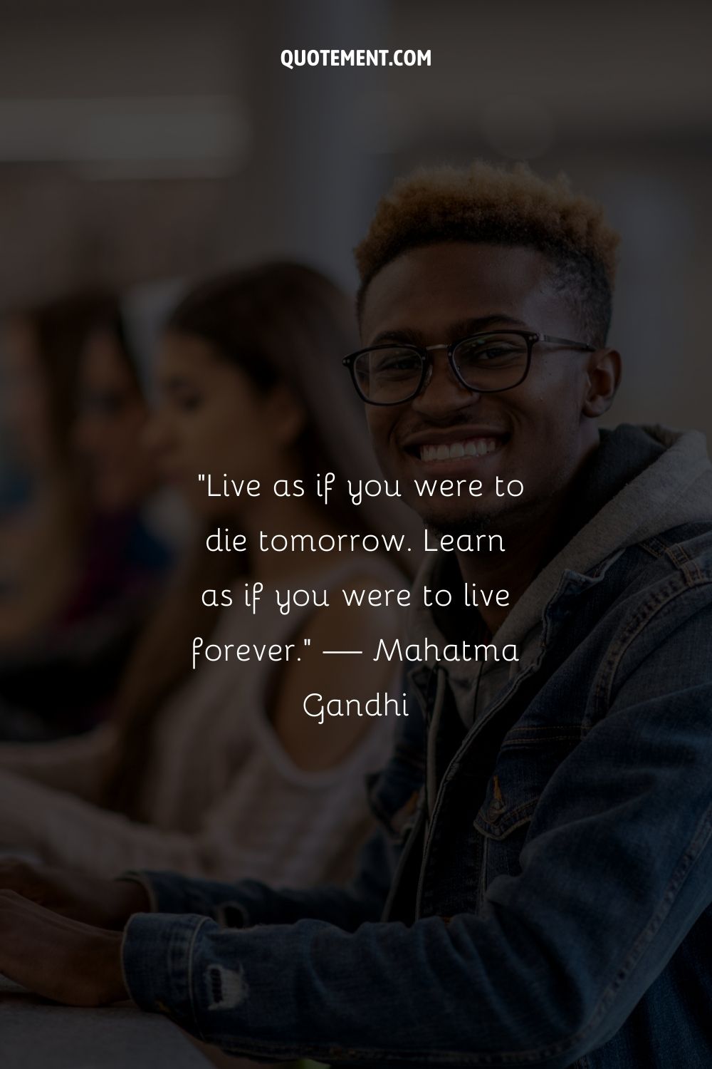 A joyful young man with glasses representing an encouraging motivational quote for students
