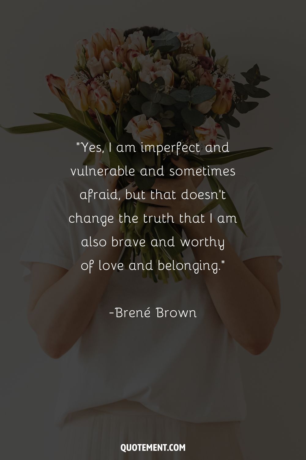 A woman is holding a bouquet of tulips in front of her face representing the top 10 Brene Brown quote