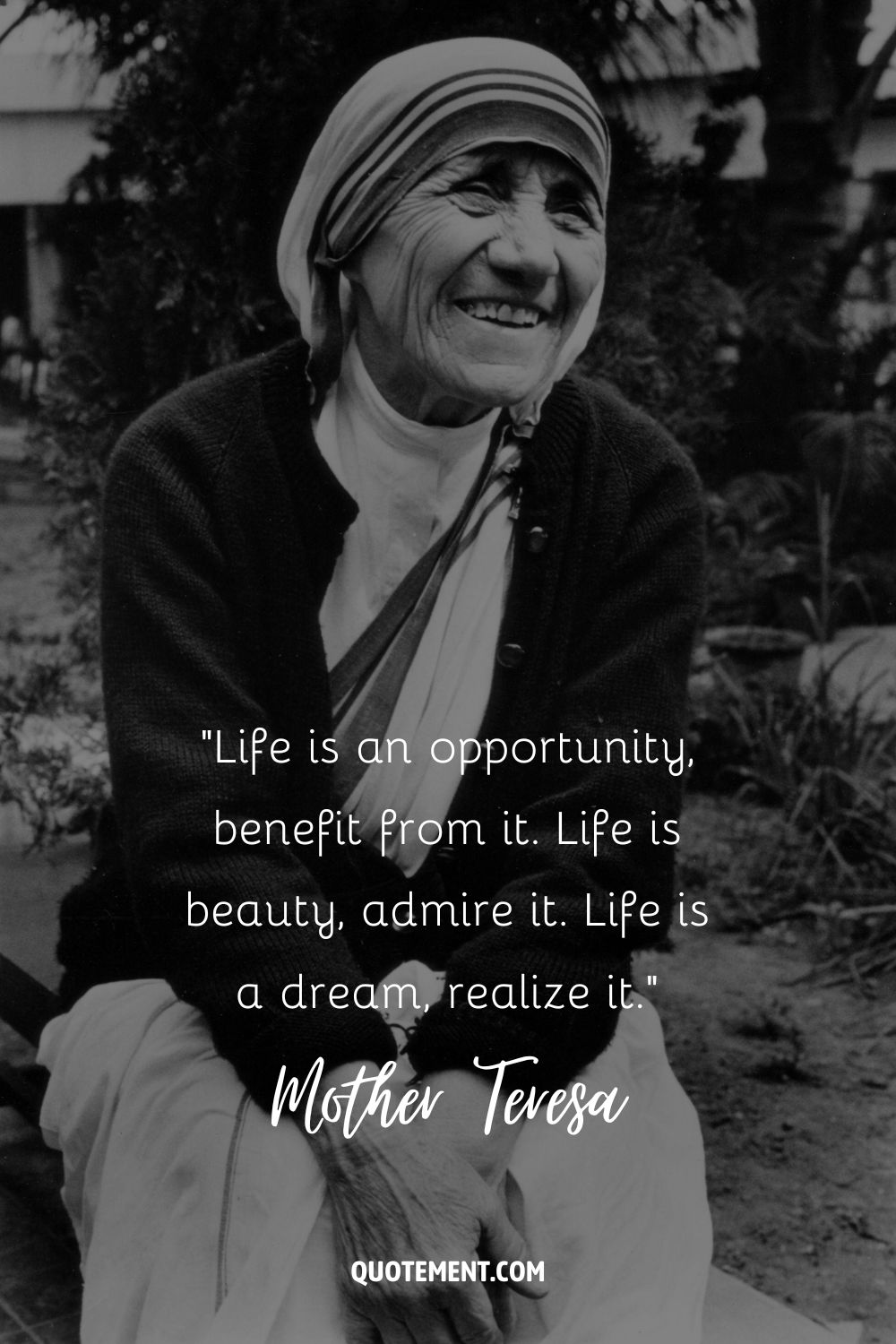 Mother Teresa sitting outdoors and smiling representing an inspiring Mother Teresa quote
