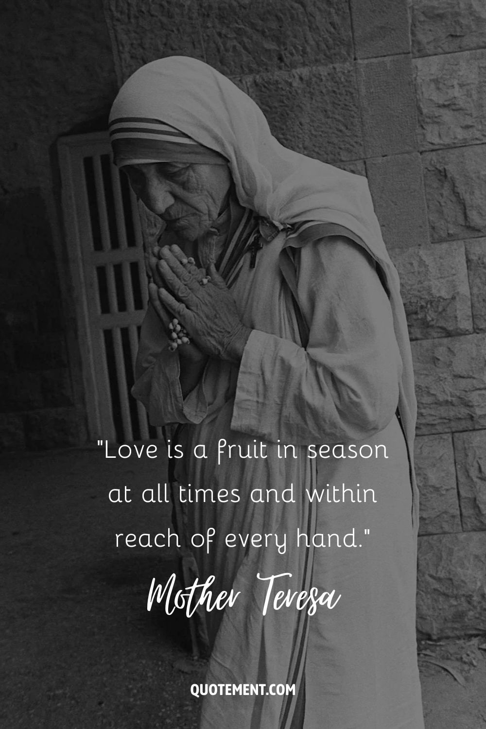 Mother Teresa standing in a prayer
